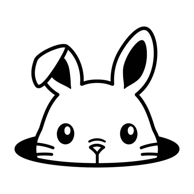 穴から顔を出すウサギ
